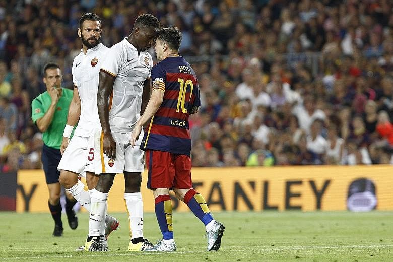 Barcelona's Lionel Messi in a rare moment of confrontation. He received only a caution for the incident with Roma's Mapou Yanga-Mbiwa but later scored in his side's 3-0 win.