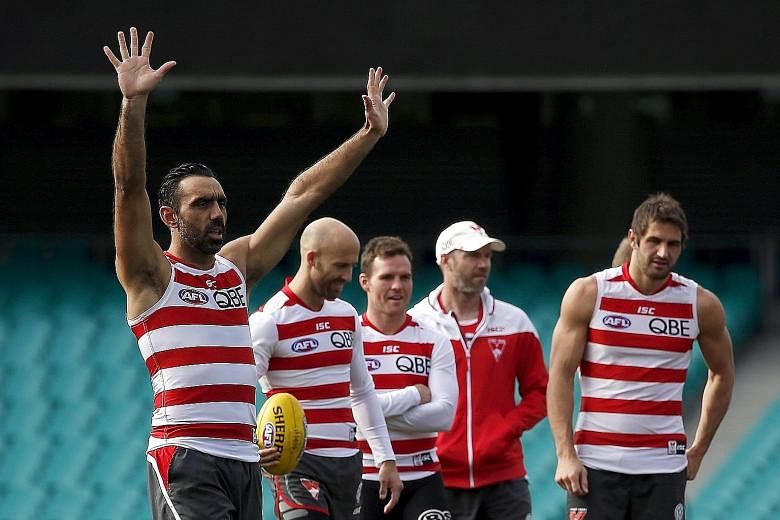 Aboriginal activist and Australian Rules football legend Adam Goodes (left) training with Sydney Swans teammates at the Sydney Cricket Ground on Tuesday. Goodes has been subject to relentless booing from rival Australian Rules crowds for months now.