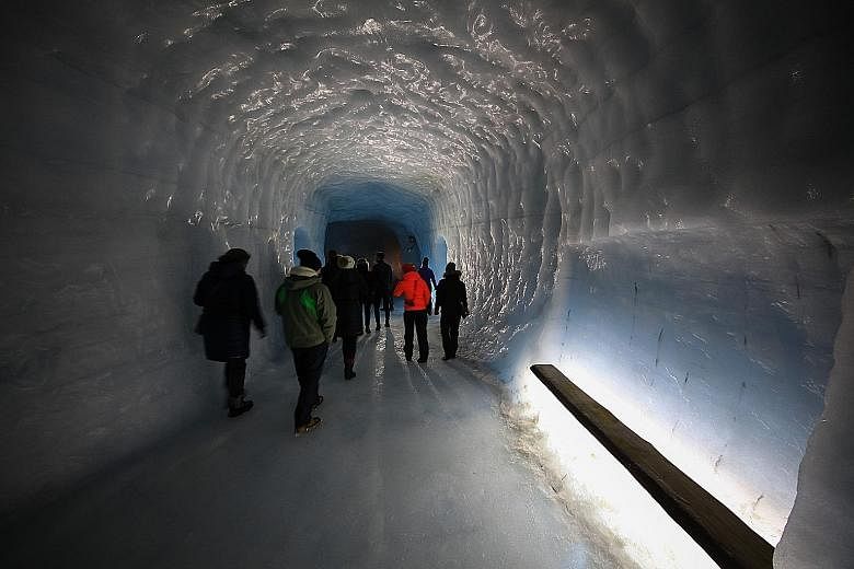 The powdery- white landscape (left) on the journey to Langjokull glacier. An entrance in the Langjokull glacier leads to a 400m-long tunnel (above) which ends at an icy "cathedral" (right).