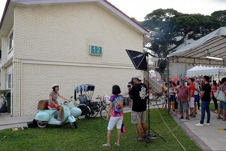 A vintage scooter with sidecar and a trishaw were part of the People's Association grassroots organisations' 1960s-themed celebration at Dakota Crescent in Mountbatten. (Above) Residents riding mini-bumper cars during the carnival-like festivities or