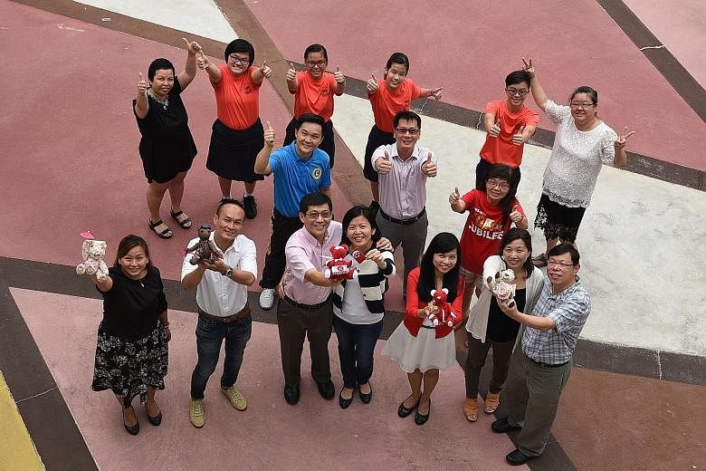 After 12 teddy bears made by Juying Secondary School students were sold for charity, teachers and staff members banded together to make another 18 bears for sale. (Back row, from left) Administrative assistant Wendy Chia, who is a member of the schoo