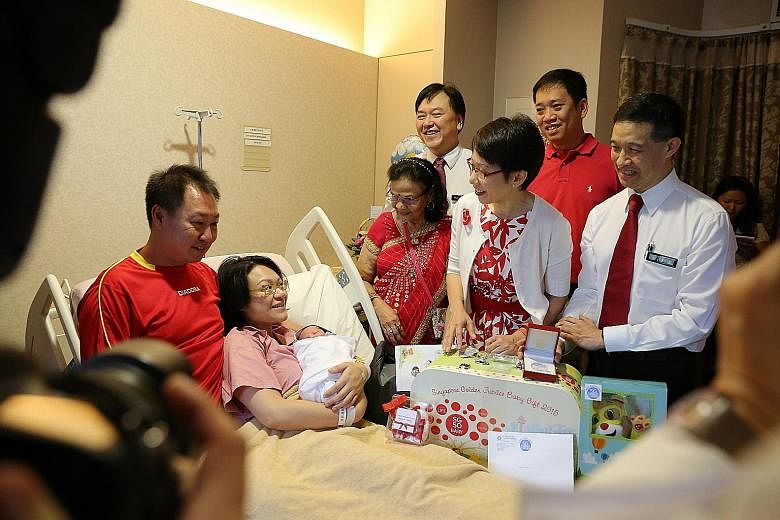 LEFT: Ms Jeissy Foo, 34, posing for a family picture with jubilee baby girl Low Yu Qing, her husband Kelvin Low, 35, and their firstborn Joanna Low, two. ABOVE: Ms Angeline Lim, 35, with her baby boy Ryker Jedd Ng and husband Ng Ming Jay, 45, speakin