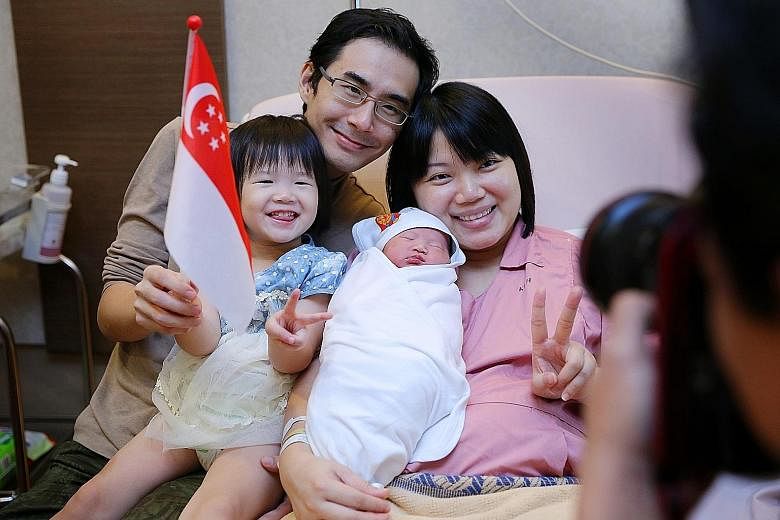 LEFT: Ms Jeissy Foo, 34, posing for a family picture with jubilee baby girl Low Yu Qing, her husband Kelvin Low, 35, and their firstborn Joanna Low, two. ABOVE: Ms Angeline Lim, 35, with her baby boy Ryker Jedd Ng and husband Ng Ming Jay, 45, speakin