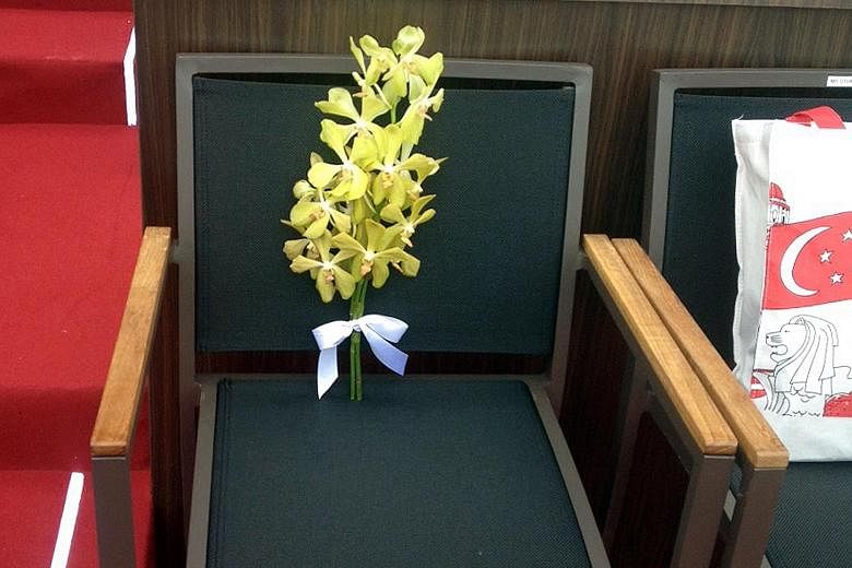 Sprigs of yellow orchid mark this seat in front of the National Gallery at the National Day Parade yesterday, in honour of Mr Lee Kuan Yew.