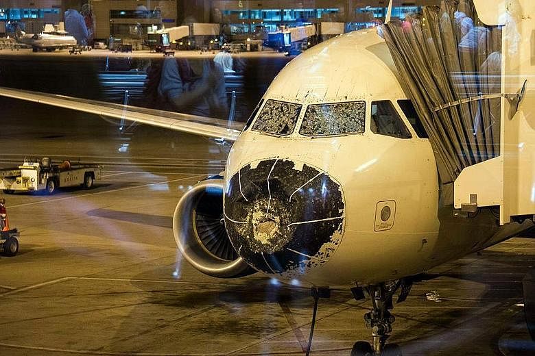 Delta Airlines Flight 1889 was forced to make an emergency landing in Denver after it ran into a hailstorm and suffered damage to its cockpit windshields and nose cone.