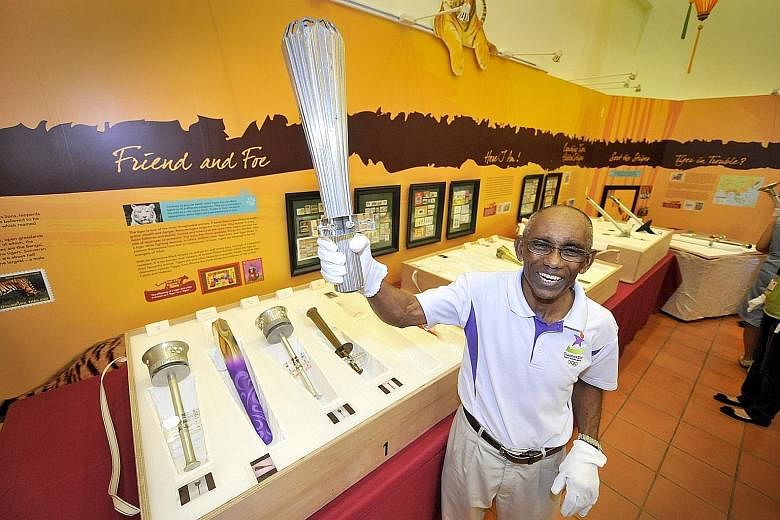 Mr C. Kunalan with a torch from the 1968 Olympic Games in Mexico. He clocked a national record time of 10.38sec in the 100m at the Games. It stood for 33 years.
