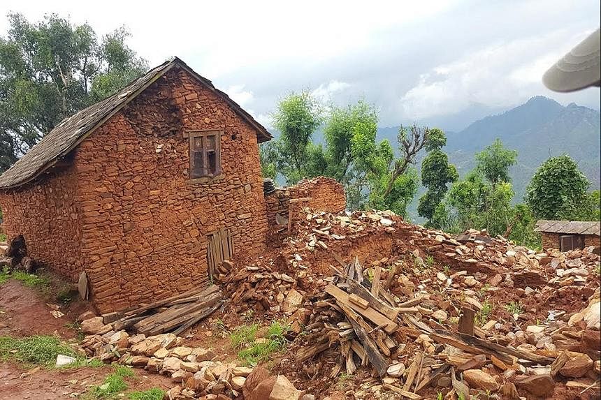 Nepalese building rice bag houses in a village near Pokhara (left), after April's devastating earthquake destroyed thousands of homes (above).