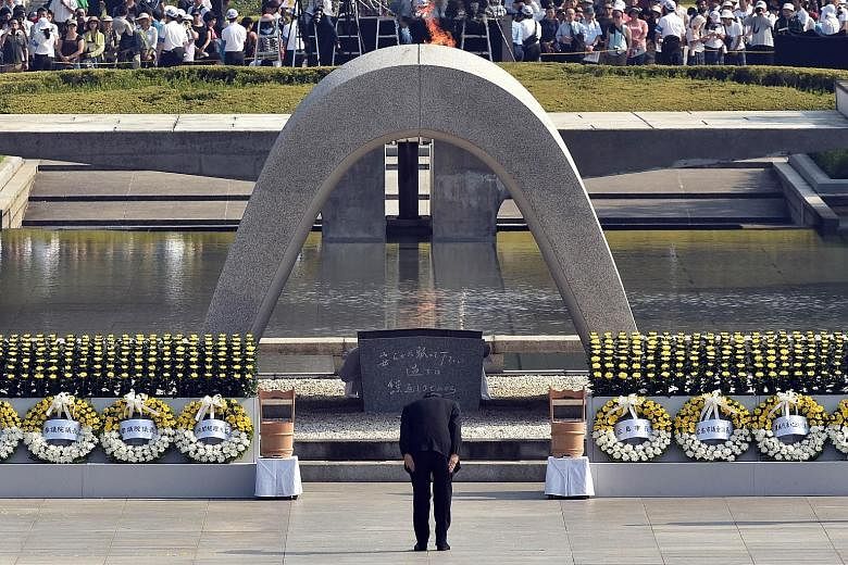 Japanese Premier Shinzo Abe bowing at the memorial for victims of the 1945 atomic bombing at a ceremony in Hiroshima to mark its 70th anniversary last Thursday. The wounds of World War II linger in Asia because of Japan's inability to integrate with 