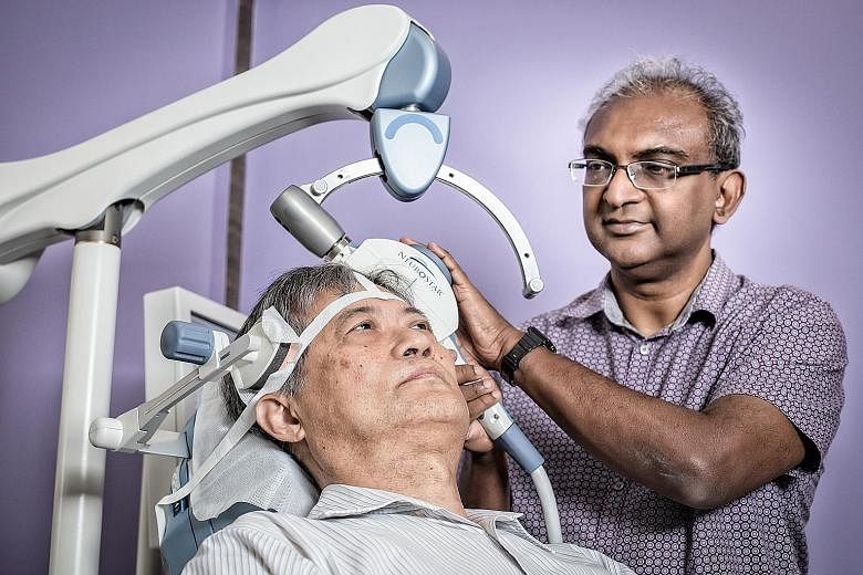 Dr Munidasa Winslow, a psychiatrist at Winslow Clinic, administering repetitive transcranial magnetic stimulation (rTMS) on a patient. In some rare cases, rTMS may induce seizures and mania, but it has mostly only mild side effects, if any at all.