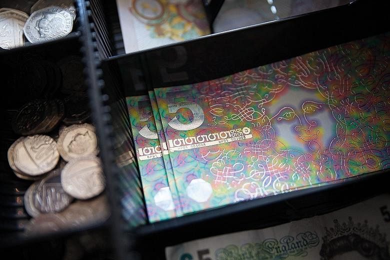 A psychedelic £5 note (top) designed by artist Jeremy Deller for the Brixton area of London, a £10 note (above left) featuring singer David Bowie and a colourful £20 note (above) for the city of Bristol.