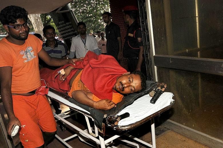 An injured pilgrim being taken to hospital yesterday after a stampede at the Baidyanath Jyotirlinga temple complex.