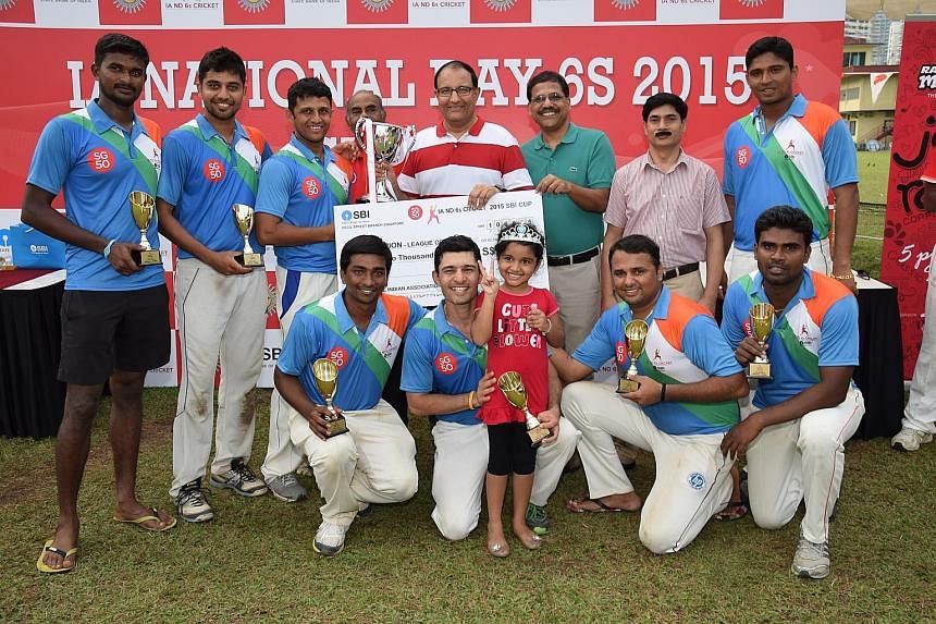 Above: The victorious India team with minister S. Iswaran (in red-and-white top) after claiming the League of Nations trophy at the Indian Association's National Day Sixes tournament yesterday. Right: Sri Lanka's Thusara Kodikara getting bowled in th