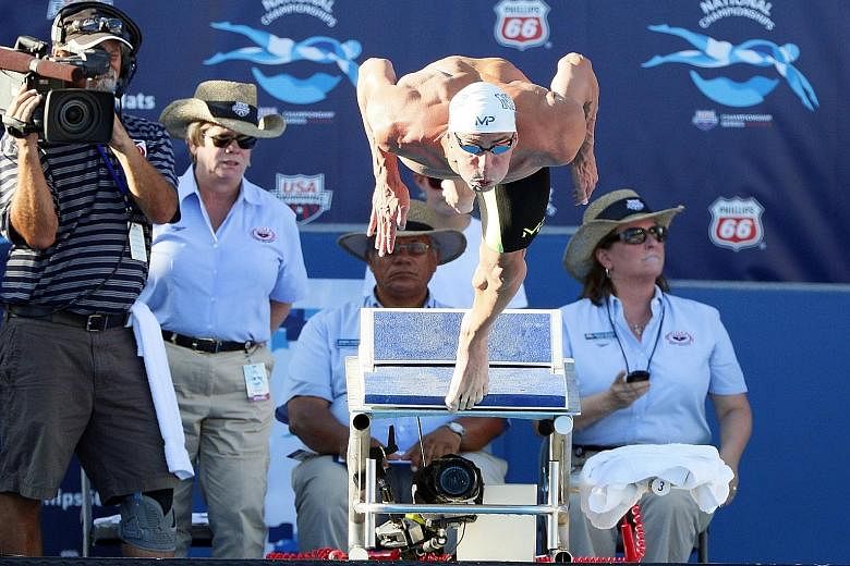 Michael Phelps signalled his intent for next year's Rio Olympics with scintillating swims at the US championships.