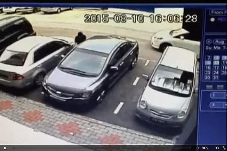A CCTV video posted by Mr Khoo shows a white car stopping next to his grey car before a man gets out, unlocks the driver-side door of the six-year-old Honda Civic and drives it away.