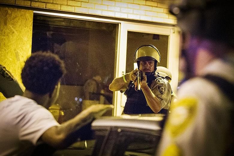 St Louis County police yesterday faced off against demonstrators in Ferguson, Missouri, as violence erupted following the first anniversary of the fatal shooting of black teen Michael Brown by a white police officer.