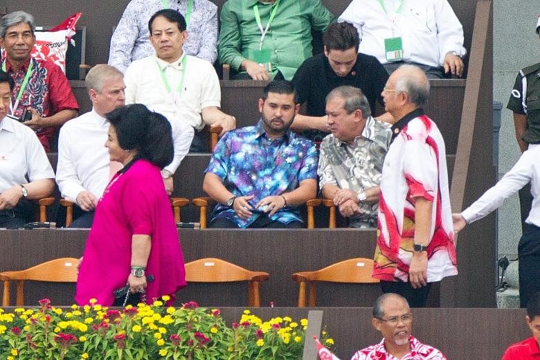 A photo showing Mr Najib (right) walking behind his wife Rosmah at Singapore's National Day celebration on Sunday. Seated on the right of the front row are Johor Sultan Ibrahim Ismail and Johor Crown Prince Tunku Ismail Sultan Ibrahim.