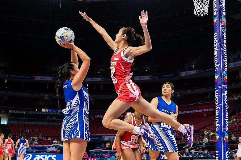 Singapore goalkeeper Micky Lin leaping to block Samoa's goal attack Julianna Naoupu, as goal shooter Auteletoa Tanimo readies for the rebound in their game, which the Pacific Islanders won 46-39.