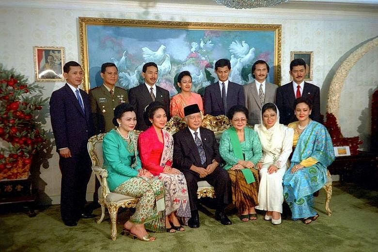 Former president Suharto and Mrs Tien Suharto (seated centre) in a photo with their children and in-laws in Cendana, Jakarta, in 1993. Under the Supreme Court ruling on July 8 but made public only yesterday, the late president's six children and the 
