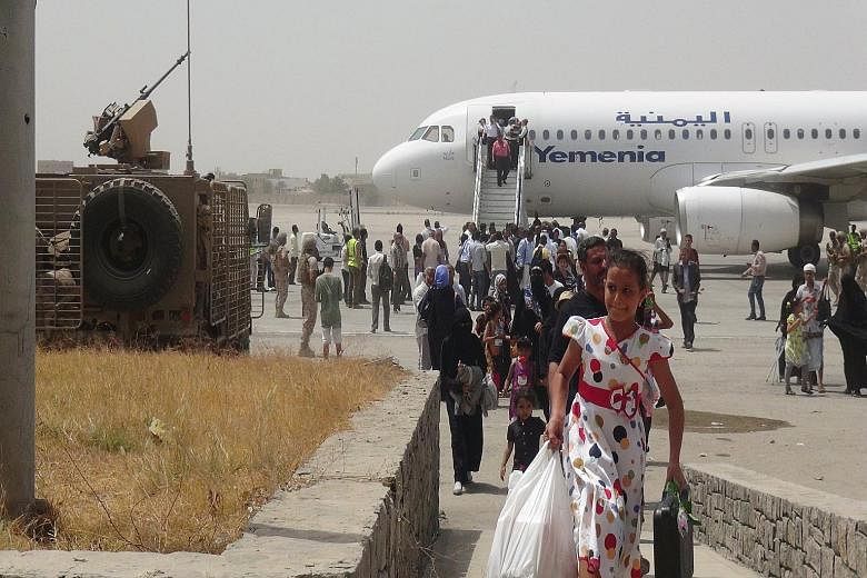 Passengers disembarking from a Yemen Airways plane at the airport in Yemen's southern port city of Aden. Fighters backed by Gulf countries retook the airport from the Houthis last month, in a turning point in the civil war.