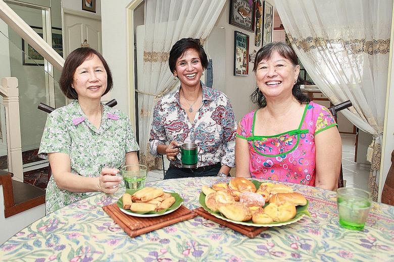 Mrs Ginger Tiah (right) with fellow Seletar Hills residents Patricia Lee (left) and Celina Gibson. Mrs Tiah oversees the production of the estate's quarterly newsletter, with the aim of building a sense of camaraderie and awareness about the estate's