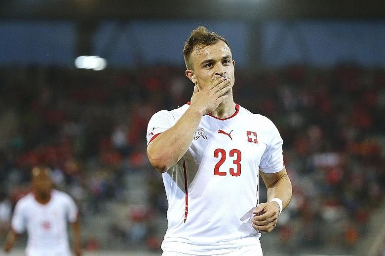 Swiss player Xherdan Shaqiri joins Stoke for £12 million, as mid-tier clubs also spend big.