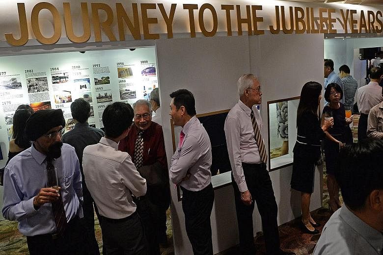 Retired pilot Kenneth Toft (right) was among a generation of transport pioneers at the Transport Ministry's SG50 gala dinner, which also featured an exhibition (above) on local transportation since independence.