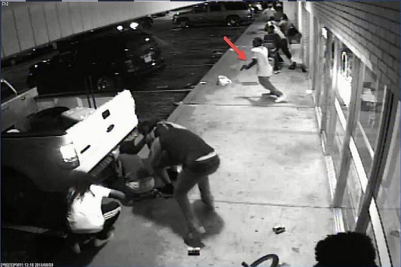 In this 13-second clip, police say the man indicated by the arrow is Tyrone Harris, who has been accused of firing on the police.