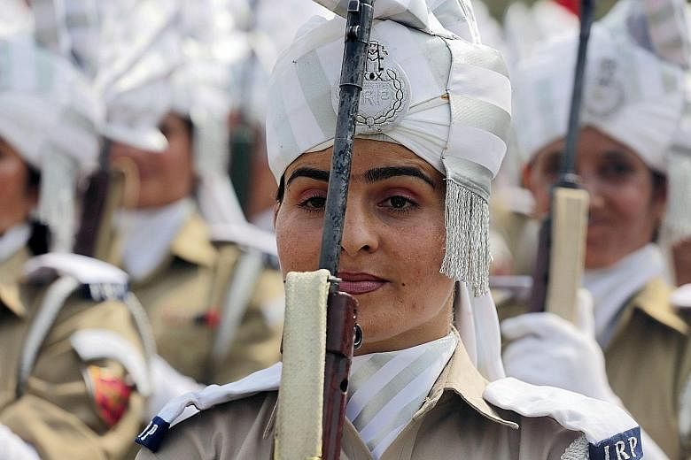 Female members of the Indian police force taking part in an Independence Day parade rehearsal yesterday in Indian Kashmir, where a grenade exploded outside a mosque and injured 10 worshippers.