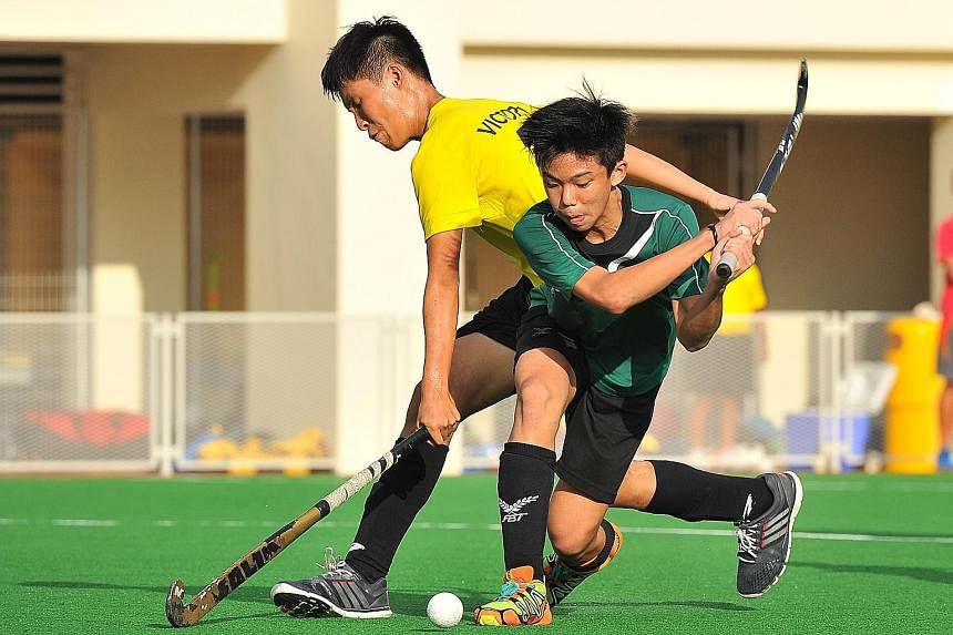 Far right: Victoria School's Issac Ho (in yellow) challenging for the ball with Raffles Institution captain Ethan Tan. RI won the C boys final 1-0. Right: Teck Whye Secondary School celebrating their C Division triumph over Crescent Girls on penalty 