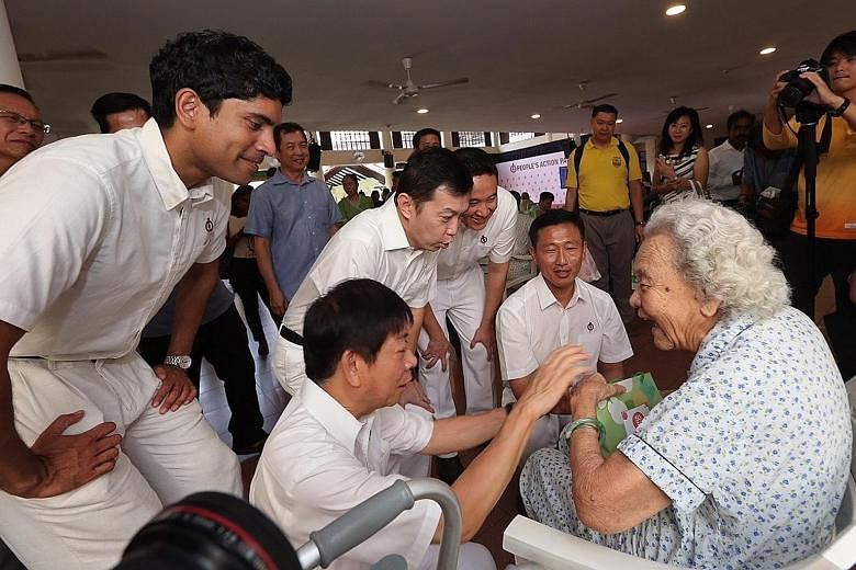 PAP candidates for Sembawang GRC (from left) Vikram Nair, Khaw Boon Wan, Lim Wee Kiak, Amrin Amin and Ong Ye Kung chatting with a resident at Sembawang's Swami Home for the elderly needy after Mr Khaw unveiled the party's new slate for the GRC. Mr Am