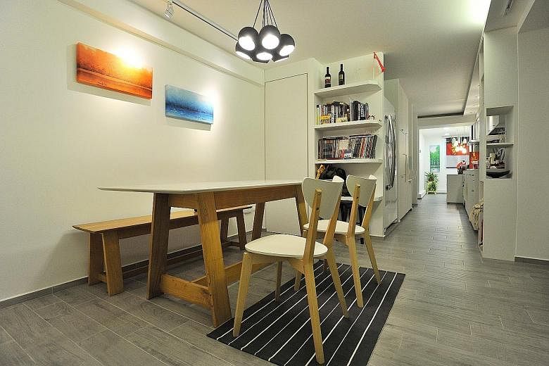 An open space beyond the kitchen is where the home owner takes her breakfast daily. Home owner Faith Goh (left) and interior designer Vincent Goi (far left), who was behind the look of her home. (Above) Ms Goh's bedroom. (From far left) Different sea