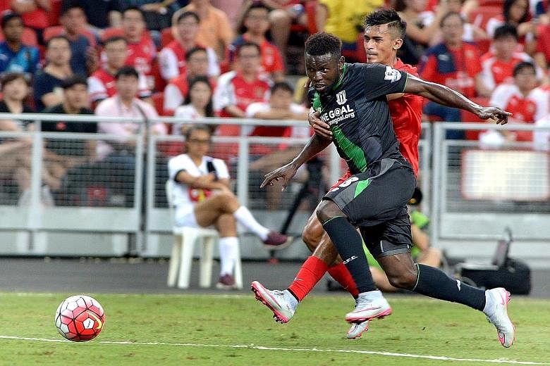 Shakir Hamzah challenging Stoke forward Mame Biram Diouf during their Barclays Asia Trophy match last month. The Singapore defender has had a spate of disciplinary issues this season, but has since knuckled down and rediscovered his best form for the