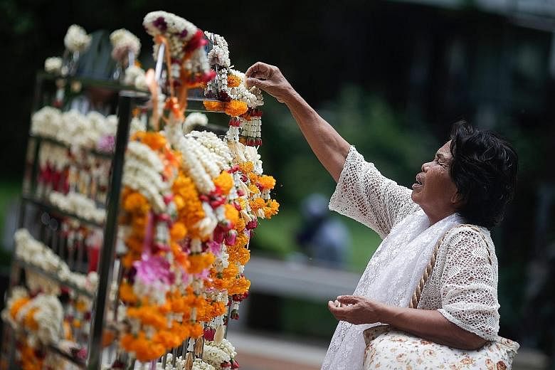 A Thai woman praying for the health of King Bhumibol Adulyadej outside Siriraj Hospital in Bangkok yesterday. The 87-year-old Thai king, the world's longest-living monarch, is recovering after treatment for water on the brain, or hydrocephalus, and a