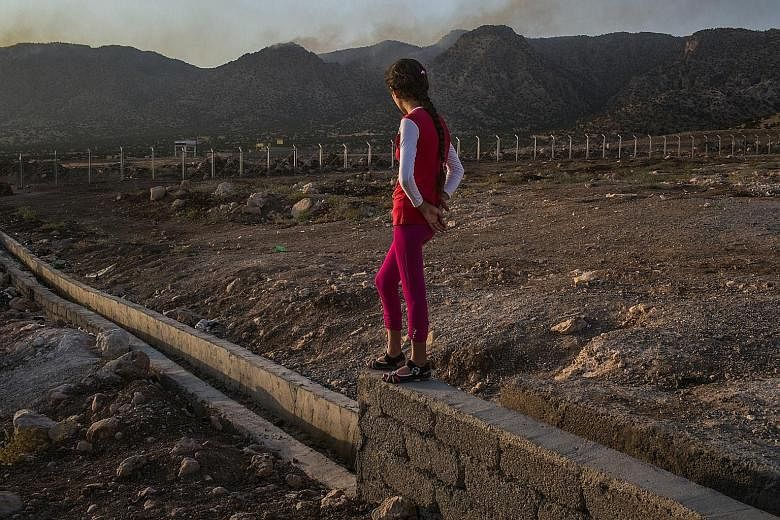 A 12-year-old Yazidi girl, who was raped by an Islamic State in Iraq and Syria fighter, at a refugee camp in Iraq. The militant group has a network of warehouses where the sex slaves are held, viewing rooms where they are inspected and marketed, and 