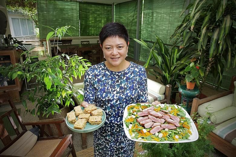 Ms Anita Fam with butterscotch bars and duck salad which she made herself.