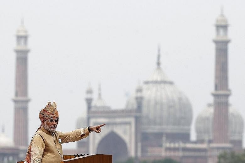 Indian Prime Minister Narendra Modi addressing the nation from the Red Fort in New Delhi (above) yesterday. He pledged to provide electricity to 18,500 villages in the next 1,000 days.