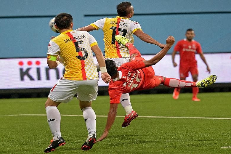 Khairul Nizam (in red) delivering his stunning late equaliser against old rivals Selangor at Jalan Besar Stadium last night, helping the LionsXII to remain in seventh spot.