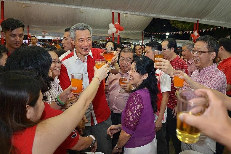 Prime Minister Lee Hsien Loong leading a toast at a National Day dinner in Teck Ghee last night. In his speech, Mr Lee said that as Singapore rose from Third World to First, so has Ang Mo Kio progressed. More improvement works are in the pipeline, he