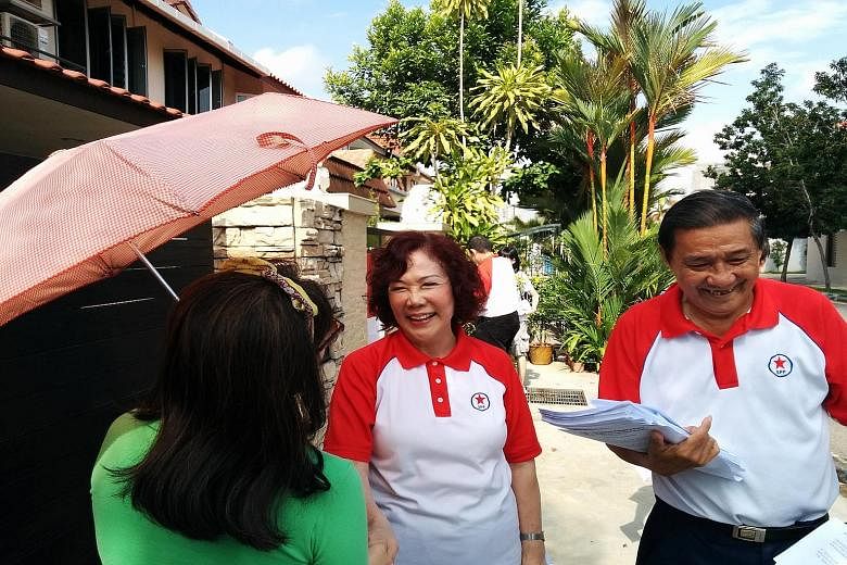 Mrs Lina Chiam, chairman of the Singapore People's Party, speaking to a resident in Sennett Estate during a walkabout yesterday.