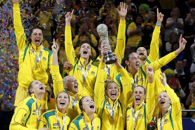Members of the Australian team celebrate as they hold aloft the trophy after retaining the Netball World Cup crown after fending off New Zealand 58-55 in the final in Sydney.