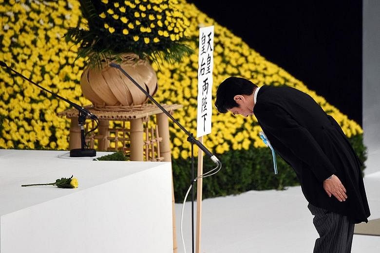 Japanese Prime Minister Shinzo Abe bowing at an altar during the annual memorial service for war victims in Tokyo on Saturday. The politically powerful Japanese nationalist right, of which Mr Abe is a member, has repeatedly questioned the existence o