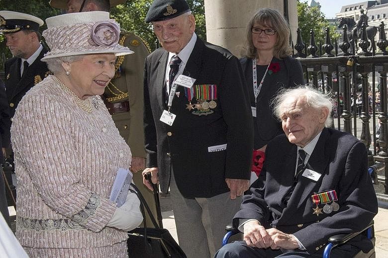 Queen Elizabeth greets veterans as she leaves St Martin's-in- the-Fields church. She was there to attend a service commemorating the 70th anniversary of VJ Day in London on Saturday.