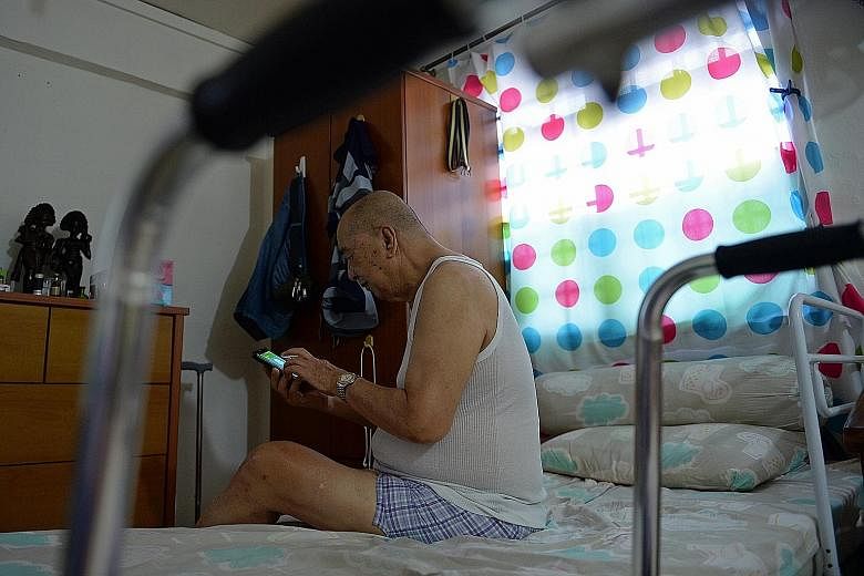 Mr Tan Ngian Wee, 80, calling friends to let them know he has reached home safely. He rarely leaves his one-room rental flat in Chin Swee Road, except for visits to the nearby Hua Mei centre for physiotherapy and other programmes.