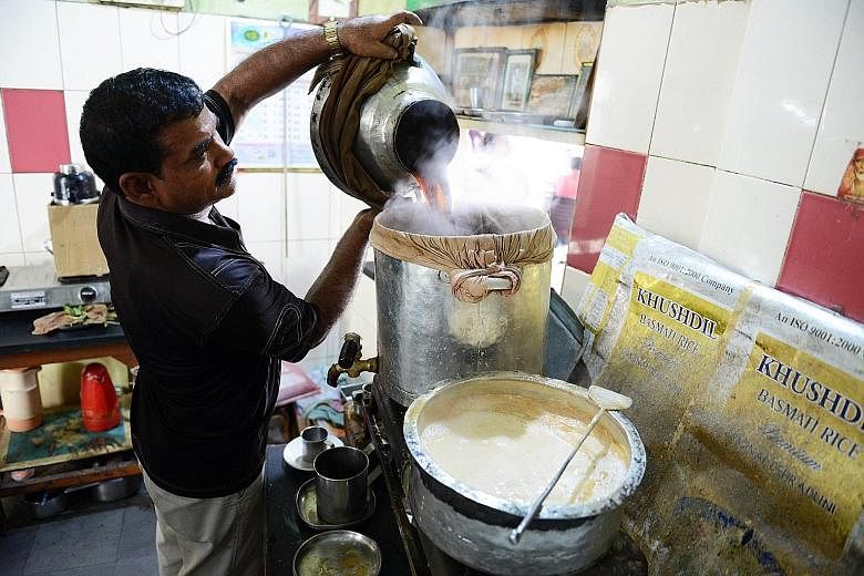 A worker prepares Irani chai tea in The May Rose Cafe in Hyderabad. Irani chai once defined the cafe culture in India, having been a tradition since the 1940s. But it is today losing territory to the onslaught of modern coffee joints. Introduced by s