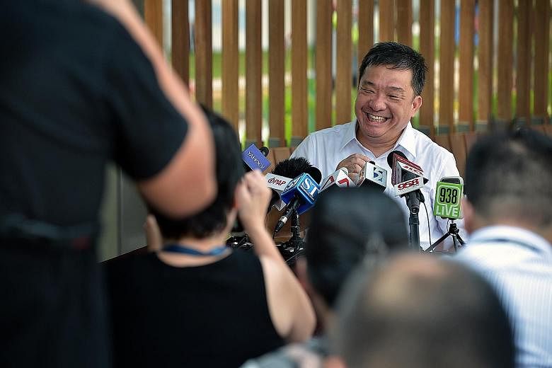 Mr Sitoh Yih Pin holding a press conference at the Kallang River ABC Park, outside the PAP branch office, yesterday. The informal session was in keeping with his preference of eschewing PAP bigwigs in favour of focusing on "earning the trust of and w