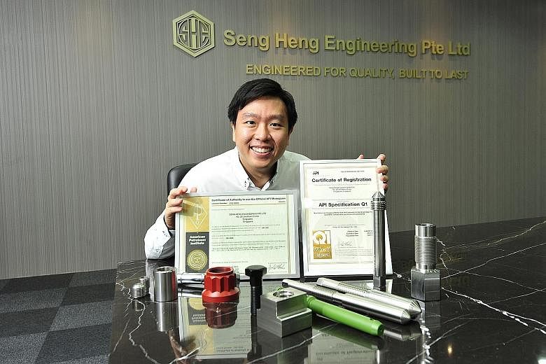 Mr Jackie Lau, managing director of Seng Heng Engineering, with the American Petroleum Institute certificates and samples of fasteners that the company makes.