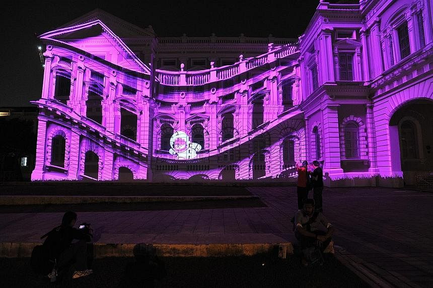 The facade of the National Museum comes alive with animated characters Anook and Nooki, the world's smallest Inuits. They are part of a light art installation entitled "The Anooki Celebrate Singapore" by David Passegand and Moetu Batlle from France. 