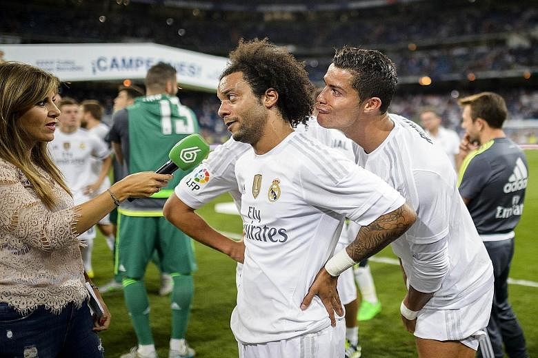 Cristiano Ronaldo (right) channels his inner prankster as Real Madrid team-mate Marcelo speaks to a journalist after their side's 2-0 victory over Galatasaray in Madrid on Tuesday.