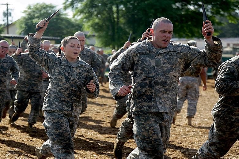 Recruits roughing it out at the elite Ranger School in Georgia. Tomorrow, two American women will be the first female soldiers to graduate from the school, which conducts the US Army's premier leadership course and one of the most challenging and exh