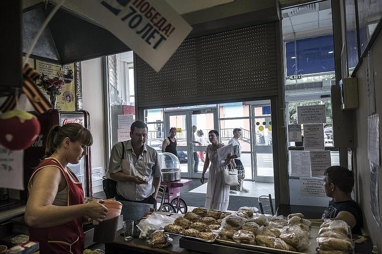 At Arina's Hangout, a tiny shop near the train station in Ramenskoye, sales are down by almost half. Russians are experiencing the first sustained decline in living standards in the 15 years since Mr Putin came to power. The rouble has fallen by half